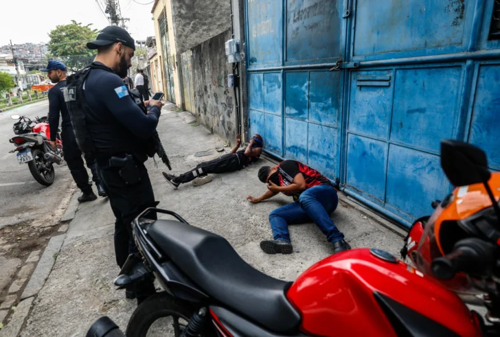  RÍO DE JANEIRO (BRASIL), 28/10/2025.- Integrantes de la Policía de Río de Janeiro custodian a dos personas durante un operativo policial este martes, en Río de Janeiro (Brasil). Una gran operación contra el narcotráfico en favelas de Río de Janeiro ha causado por lo menos 64 fallecidos y 81 detenidos, en la que ya es la acción policial más sangrienta realizada en esa ciudad de Brasil, informaron fuentes oficiales. EFE/ Antonio Lacerda