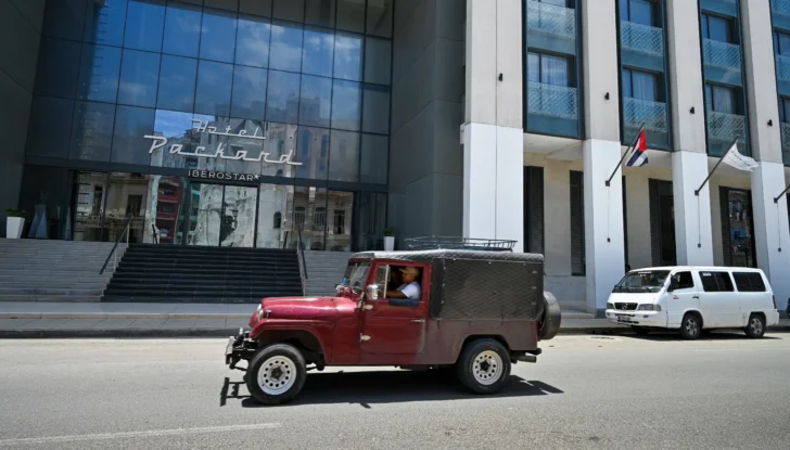  Un vehículo pasa por la entrada del hotel Iberostar Packard en La Habana, el 2 de junio de 2026. El grupo hotelero español Iberostar se ha retirado de la gestión de una docena de hoteles en Cuba que operaba en asociación con el conglomerado Gaesa, vinculado al ejército y sujeto a sanciones estadounidenses, según informaron a la AFP varias fuentes cercanas al asunto el 2 de junio de 2026. (Foto de ADALBERTO ROQUE / AFP)