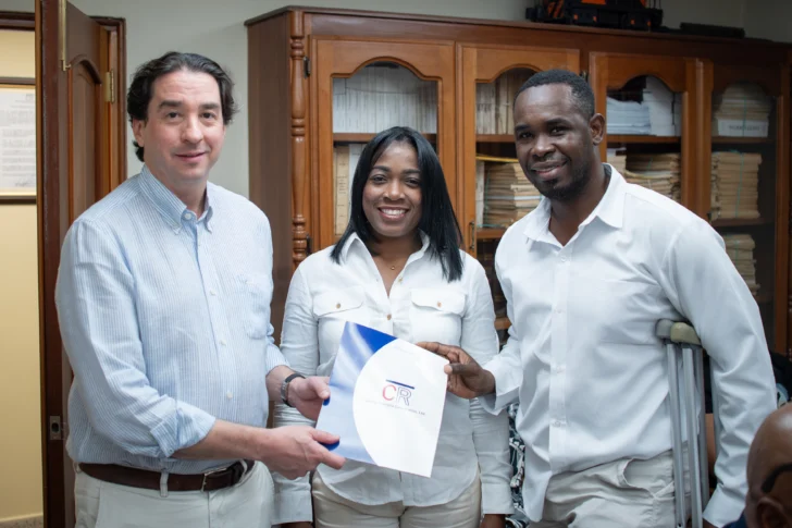 Moises-Sanfo-Jaudi-recibe-junto-a-su-esposa-el-contrato-de-donacion-de-vivienda-luego-de-mas-de-20-anos-trabajando-en-Central-Romana-728x485